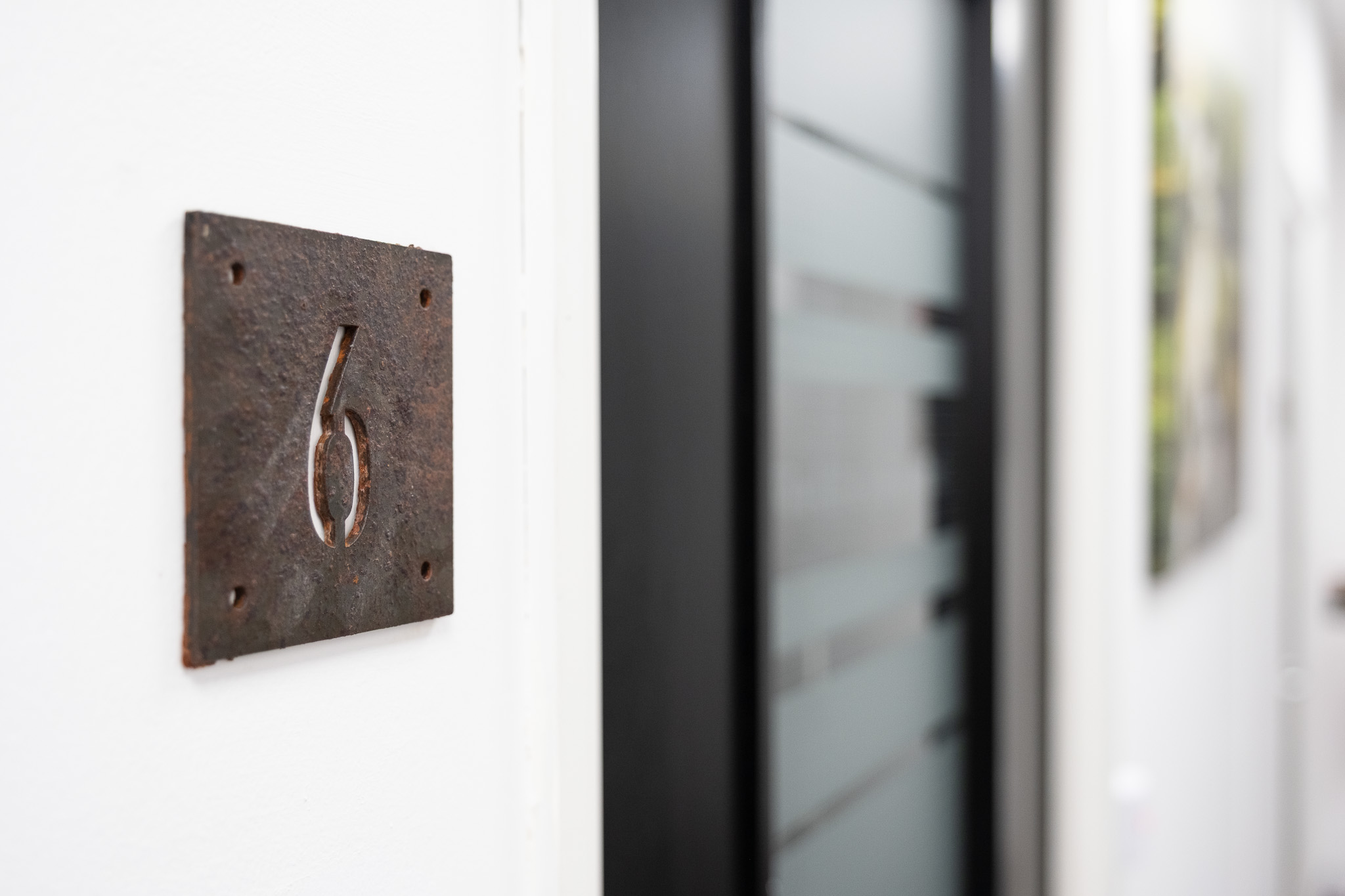 Close up on door sign number for office 6, 4 Tannery House with corridor in background