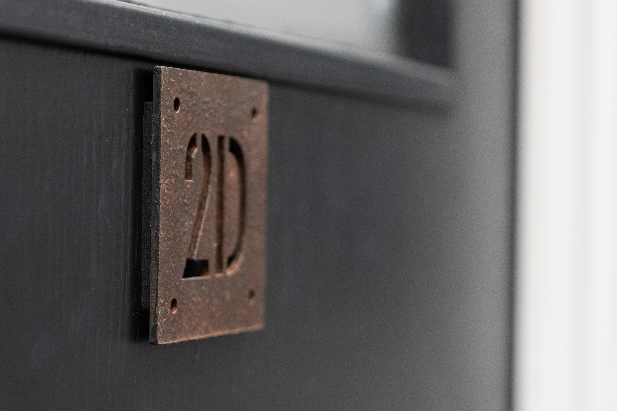 Close up on door sign number for office 2C, 3 Tannery House with corridor in background